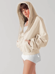 Detail view of beige oversized zip-up hoodie featuring dropped shoulders and side pockets