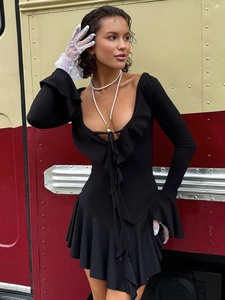 Detail of elegant black long sleeve dress with ruffle V-neckline and lace-up front detail