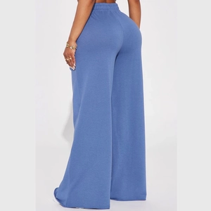 Back view of women's high-waist wide-leg yoga pants in soft blue knit fabric