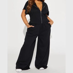 Detail of high-waisted black wide-leg pants and side pockets on a soft knit yoga set