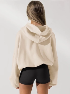 Rear view of women oversized beige zip-up hoodie showing the fit and hood detail