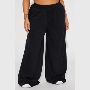 Detail of high waist elastic waistband on black wide leg yoga trousers for women