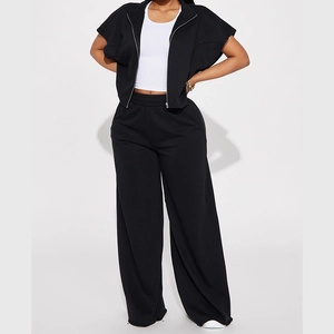 Detail of high-waisted black wide-leg joggers with elastic waistband and cotton texture