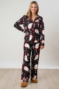 Detail of Christmas pajamas with Santa Claus print, red piping, and chest pocket