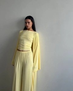Detail of pale yellow three-piece lounge set with ribbed texture and loose cardigan