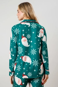 Detail of green Christmas pajamas set with Santa Claus print and red piping on cuffs