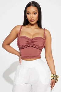 Detailed view of the dusty rose corset top with braided cord straps and ruched bust