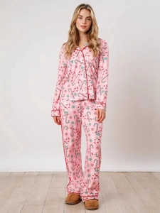 Women's pink Christmas pajama set featuring festive candy cane and snowflake patterns