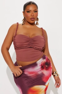 Detail of mauve sleeveless top with woven strap design and floral maxi skirt set