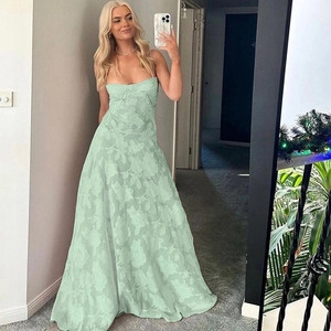 Detailed macro view of mint green strapless maxi dress with luxury floral jacquard fabric