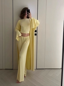 Three-piece pale yellow loungewear set with long cardigan, crop top, and wide-leg pants