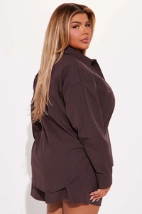 Detail of dark brown pinstripe loungewear set with oversized shirt and shorts