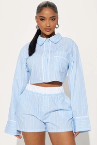 Detail of light blue striped short shirt and elastic waist shorts for summer casual wear