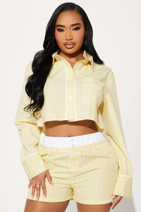 Detailed view of the yellow vertical stripe pattern and chest pocket on the summer shirt