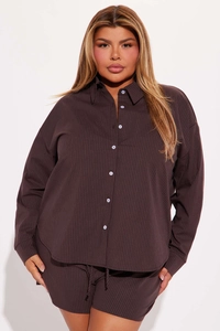Close-up of chocolate brown striped long-sleeved shirt with white buttons and collar