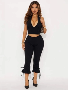 Women black slim fit two-piece set featuring halter V-neck top and cropped leggings