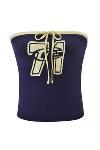Detail of navy blue crop top featuring cream trim, tied bow, and retro numbers print