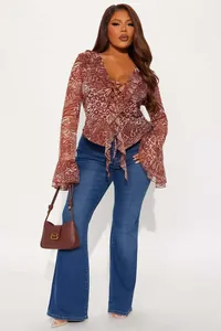Detail of ruffle cuffs and leopard print chiffon texture on a slim fit wrap top