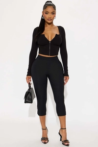 Close-up of black V-neck long sleeve zipper top and slim fit cropped pants fabric texture