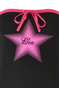Detail of black crop top featuring pink star print and adjustable drawstring neckline