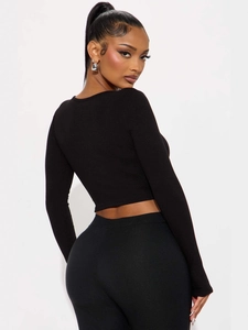 Women's black ribbed knit long sleeve crop top with slim fit design on white background