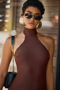 Detail of chocolate brown halter neck jumpsuit featuring smooth matte fabric texture