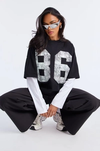 Detail of oversized layered long sleeve tee with vintage 86 print and street style aesthetic