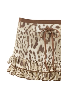 Close-up of leopard print skirt detailing elastic waistband and drawstring bow