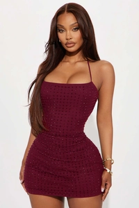 Detail shot of sparkling rhinestones on burgundy bodycon mini dress with halter neck design