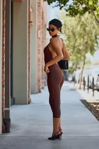 Detail of the backless halter design on this slim-fit dark brown knit midi dress