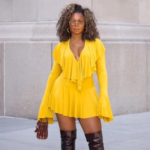 Detail of yellow V-neck dress featuring ruffled layers and dramatic flare bell sleeves