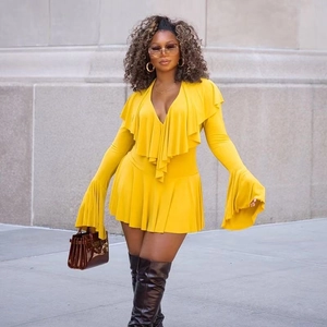 Detail of ruffle deep V-neck and flared sleeves on mustard yellow knit mini dress