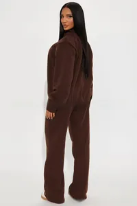 Detail of dark brown tracksuit featuring a stand-up collar and high-quality fleece texture