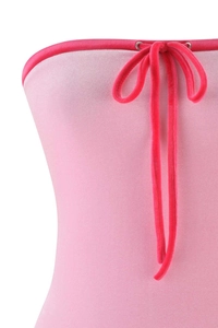 Detail of pink velvet bandeau top featuring bright pink drawstring and silver eyelets