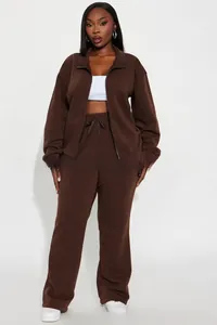 Detail of deep brown two-piece set featuring a zipper stand collar and drawstring waist