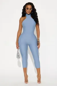 Detail of light blue sleeveless halter neck jumpsuit with a slim fit silhouette