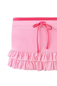 Detail of pink velvet mini skirt featuring a drawstring waist and ruffled tiered hem