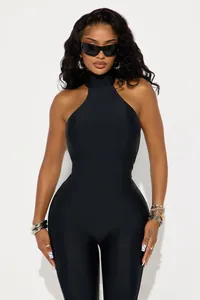 Front view of black sleeveless halter neck jumpsuit with a tight fit and matte finish