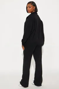 Side view of black women's two-piece track set with stand collar zipper jacket and pants
