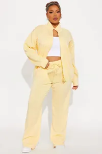 Detail of light yellow women's track set with stand collar zipper and drawstring pants