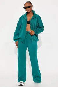 Detail of dark green tracksuit with stand collar zipper jacket and drawstring trousers