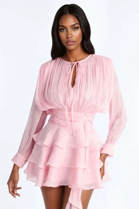 Detail of light pink tiered mini dress with pleated chest design and waist tie belt