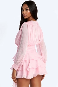 Detailed back view of pink long sleeve mini dress with layered ruffle skirt design