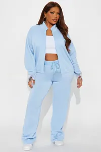 Detailed close-up of light blue knit texture on standing collar zip-up jacket set