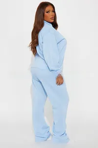 Side view of light blue women's two-piece tracksuit set with high collar and sweatpants