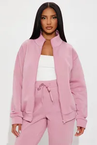 Detail of pink two-piece tracksuit set with zip-up collar jacket and drawstring pants
