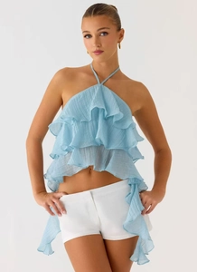 Dettaglio del top all'americana azzurro con volant e texture in tessuto leggero