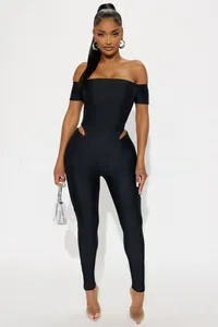 Detail view of black off-the-shoulder bodysuit with side cut-outs and glossy slim fit