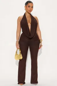 Detail of deep brown halter neck jumpsuit featuring an open back and slim fit trousers