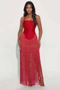 Detail of red halter dress featuring shimmering fringe hem and bodycon silhouette